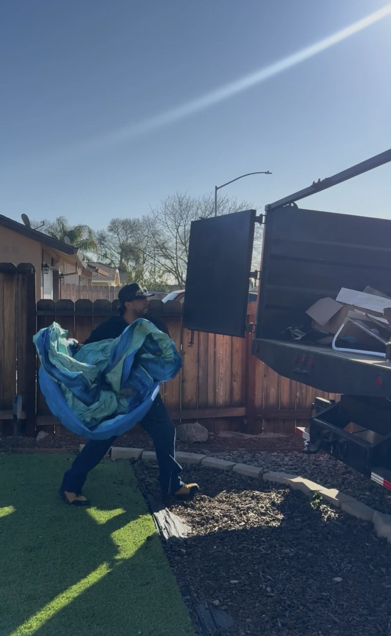 Loading junk from backyard into ScanJunk truck in Stockton