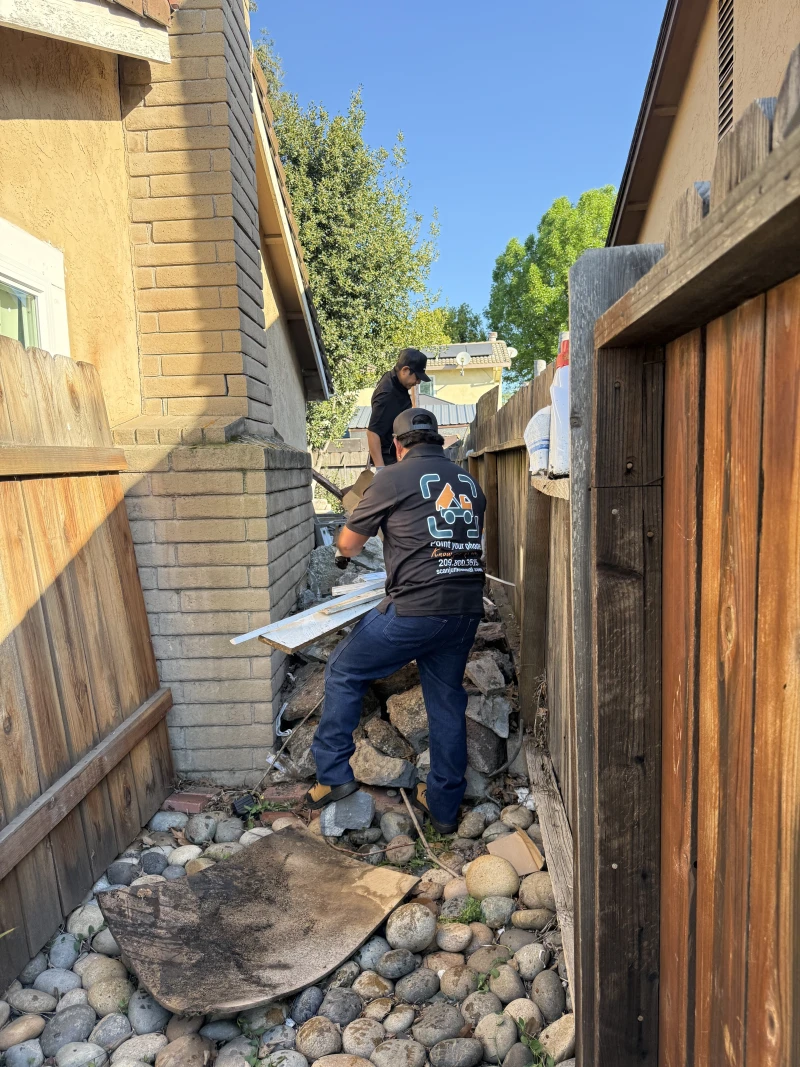 ScanJunk crew member hauling debris during porch cleanup
