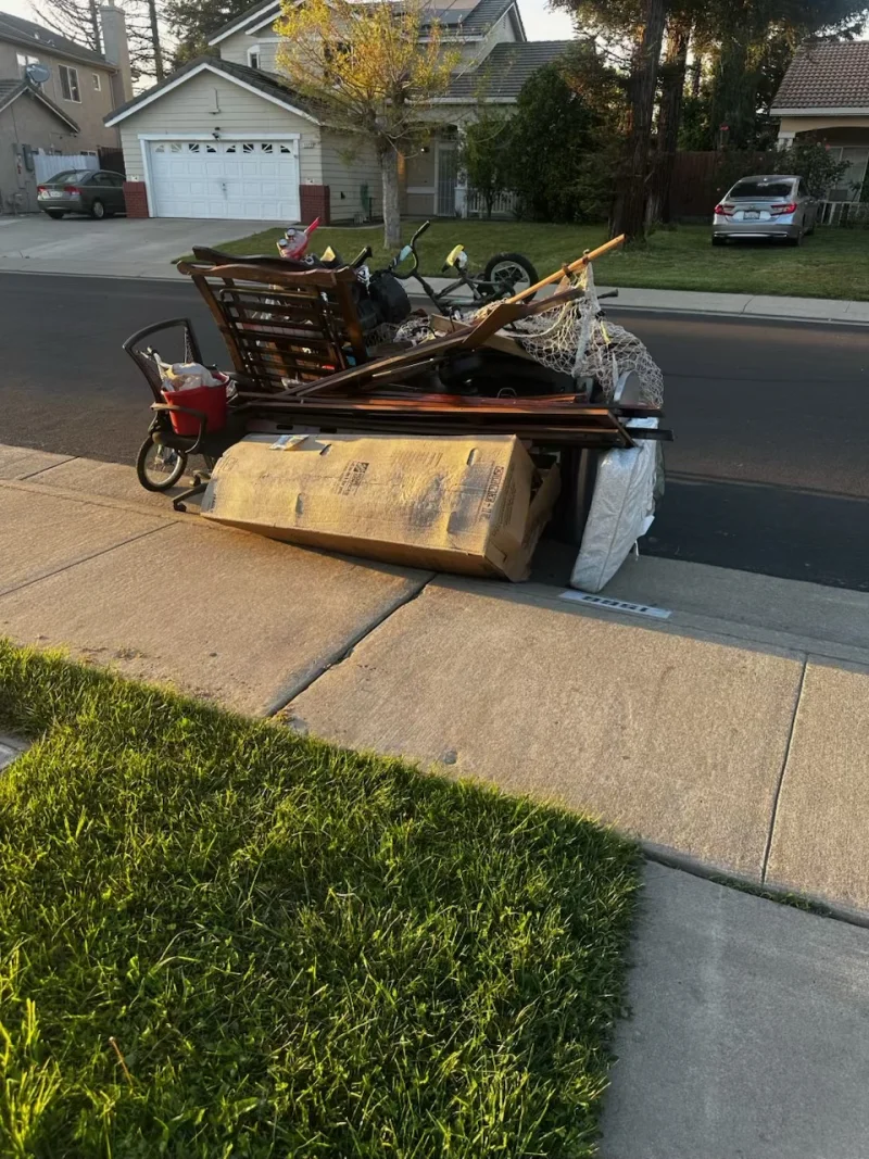 Curbside old furniture and household items waiting for junk pickup in Stockton