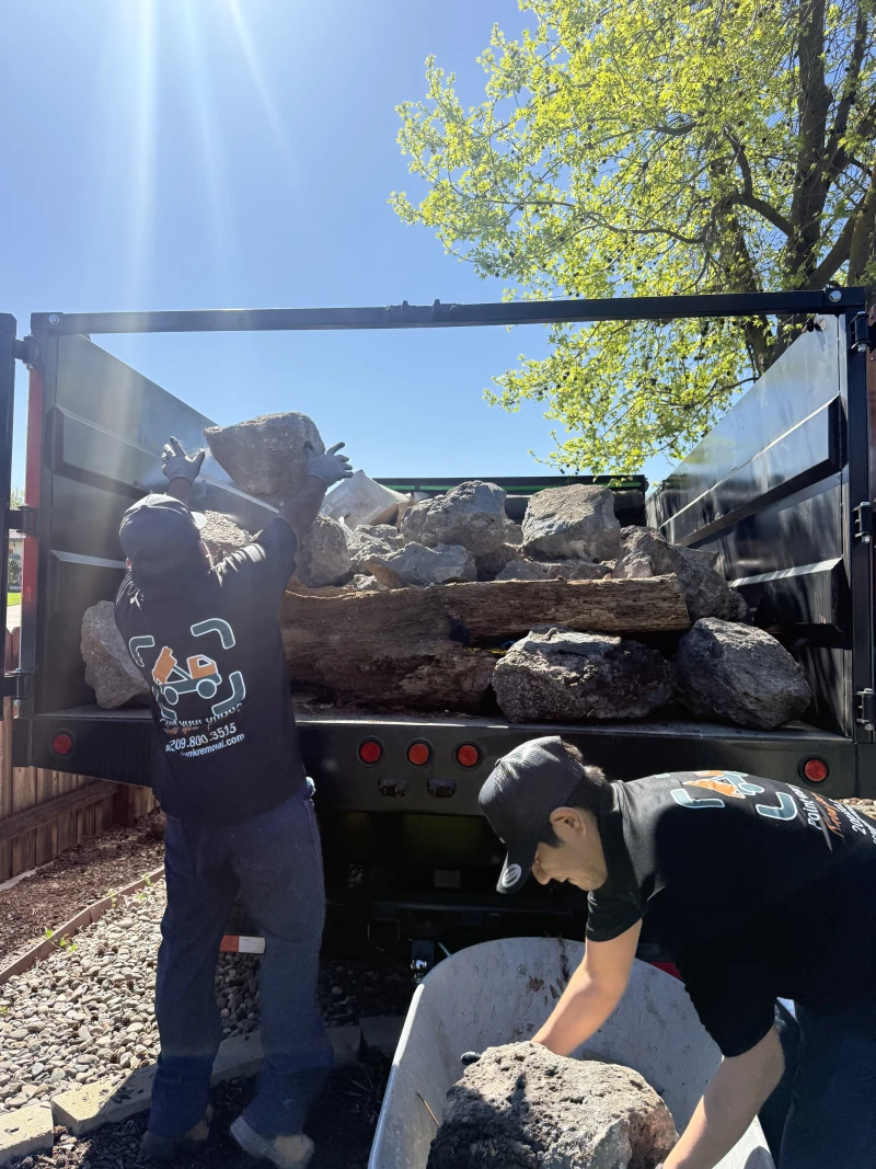 Loading heavy logs into ScanJunk dump truck