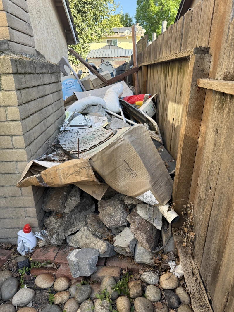 Cluttered porch with rocks and debris before ScanJunk removal in Stockton