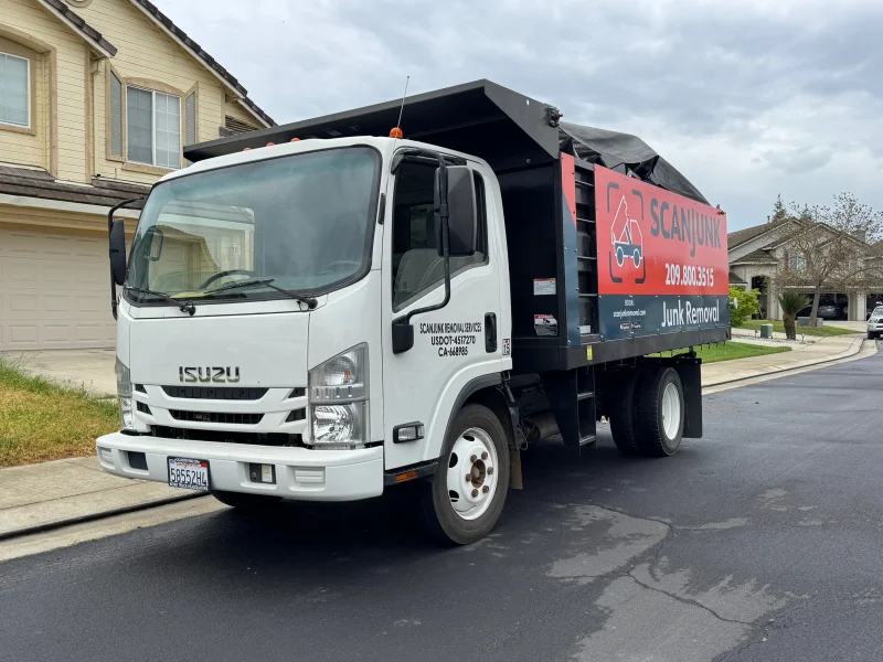 ScanJunk Removal branded Isuzu junk removal truck parked in Stockton residential neighborhood